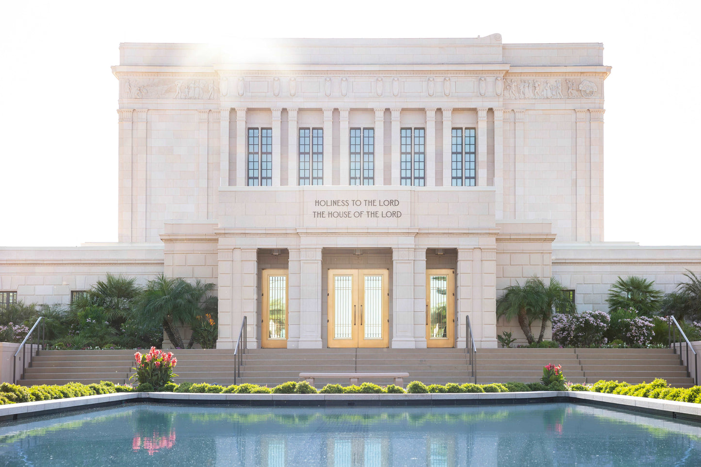 Cool blue hues of the reflecting pool contrasting subtly with the magnificent gold doors of the Mesa, Arizona Temple. Light is found everywhere on the grounds and inside- climb the stairs and enter the house of God.