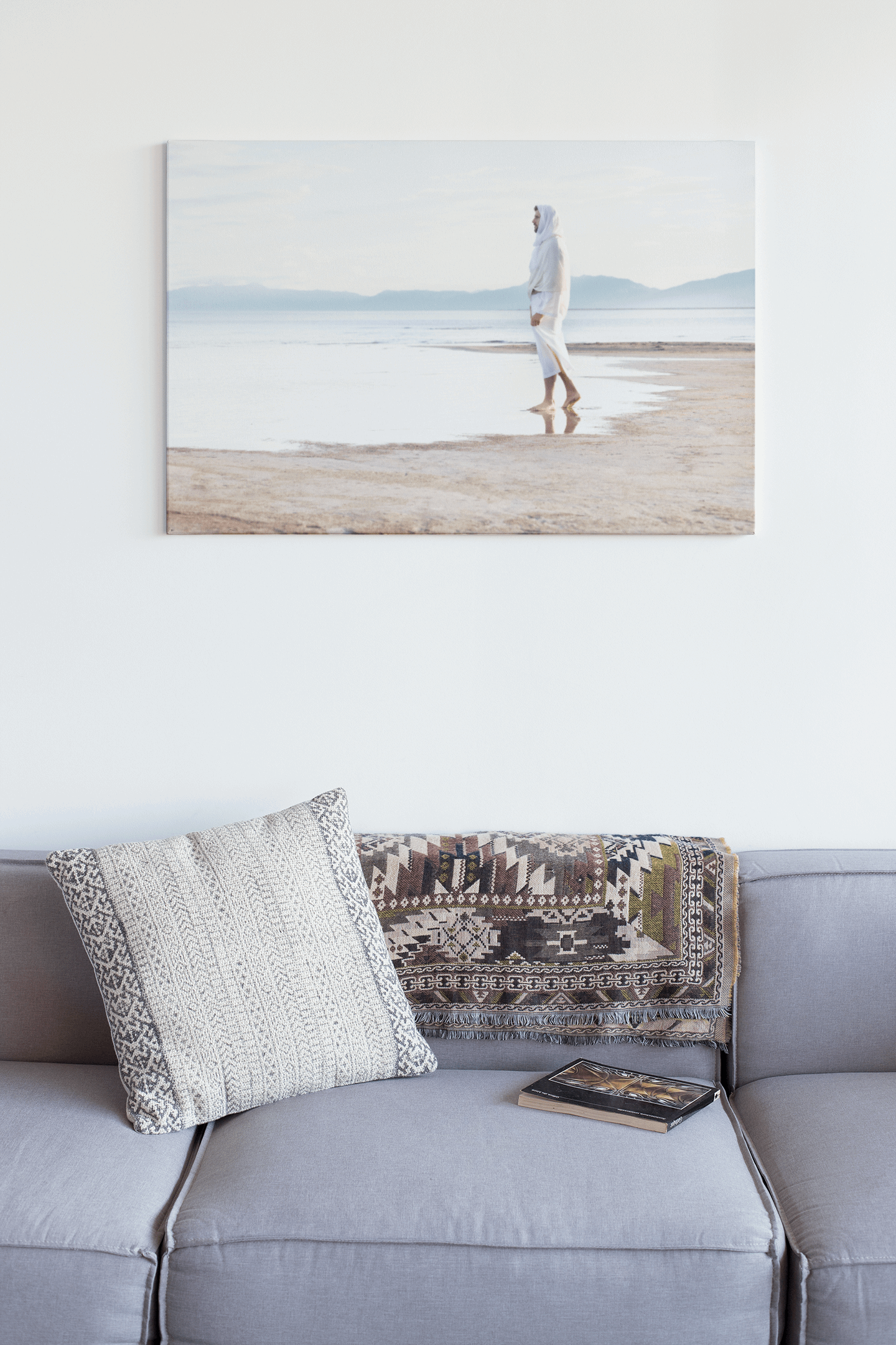 Christ on the seashore, calming still water and grey, blue, sandy neutral hues. Serene landscape of the contemplative Christ bringing calm to any room. A beautiful portrait of the Savior by H. Walker Photoart. The Prince of Our Peace is the perfect addition to any room. Religious Art.